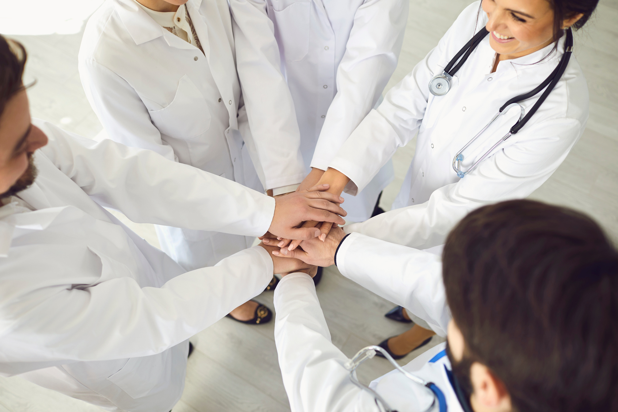 Group of Doctors Joined Hands Together. Medicine Healthcare Clinic Hospital Concept .